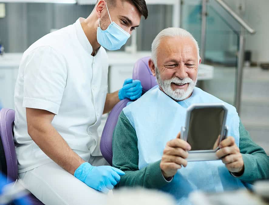 Elderly Patient Smiling After Dental Implant Surgery